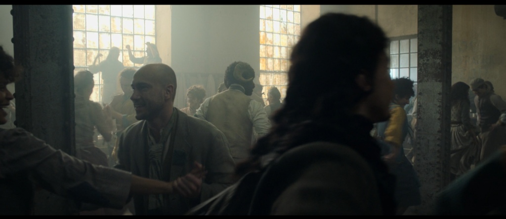 A still image from the Carnival Row TV show, showing David as an extra.
