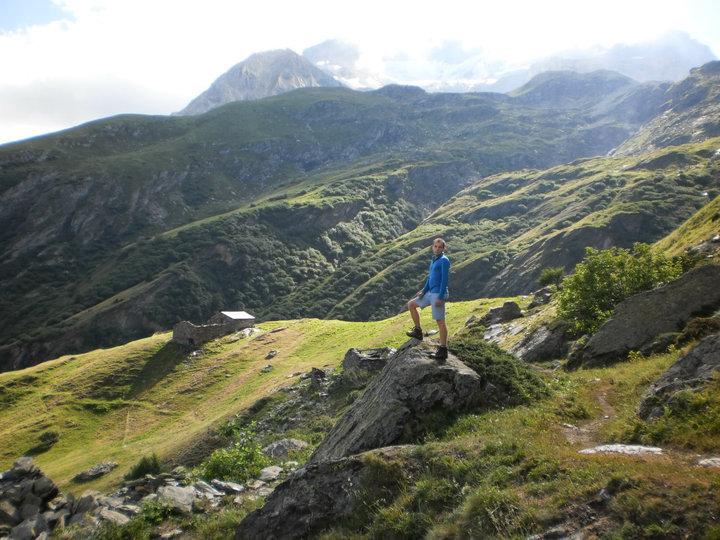 David posing for a photo during a summer hike in the green French Alps.